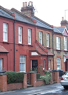 Small two-storey houses, with the front doors set in small outbuildings to open perpendicular to the front of the house