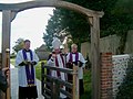 The Bishop of Horsham dedicating the tapsel gate in 2004, with the Rector and the bishop's domestic chaplain.