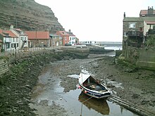 Coble in the river at Staithes at low water