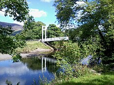 a modern metal suspension brige over a river