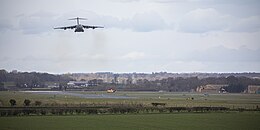 An RAF C-17 above the runway at RAF Leeming